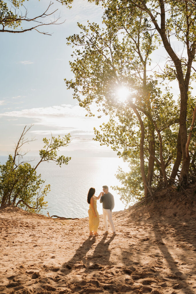 Man kissing his fiances hand at Pierce Stocking Scenic Drive.