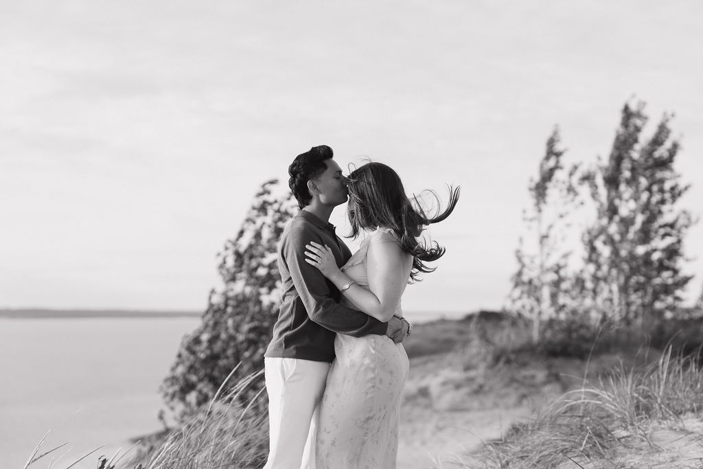 Man kissing his fiancés head at Pierce Stocking Scenic Drive.