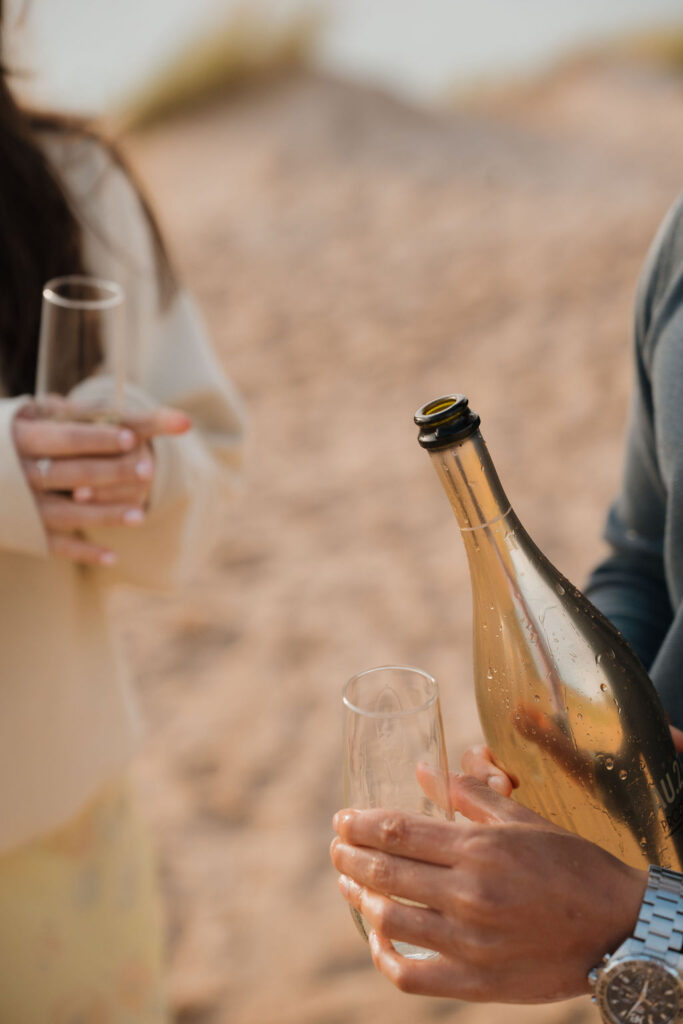 Close up shot of a couple having champagne after their proposal.