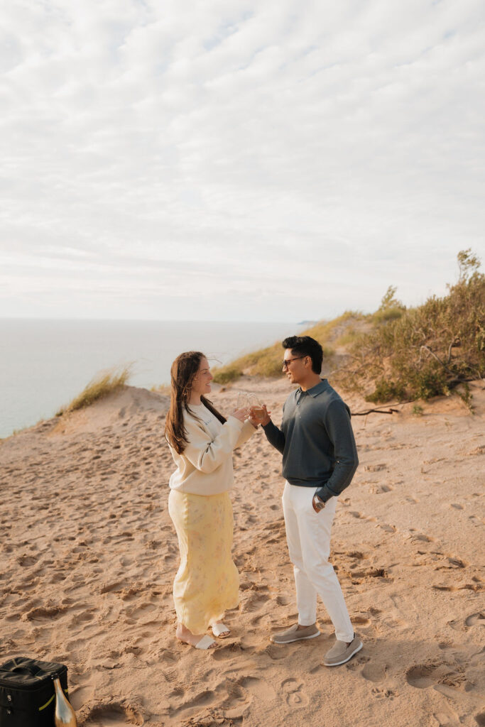 Couple toasting with champagne after their Northern Michigan proposal.