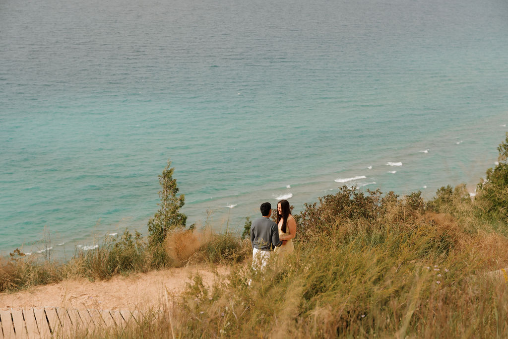 Couple talking just before a surprise Sleeping Bear Dunes proposal.