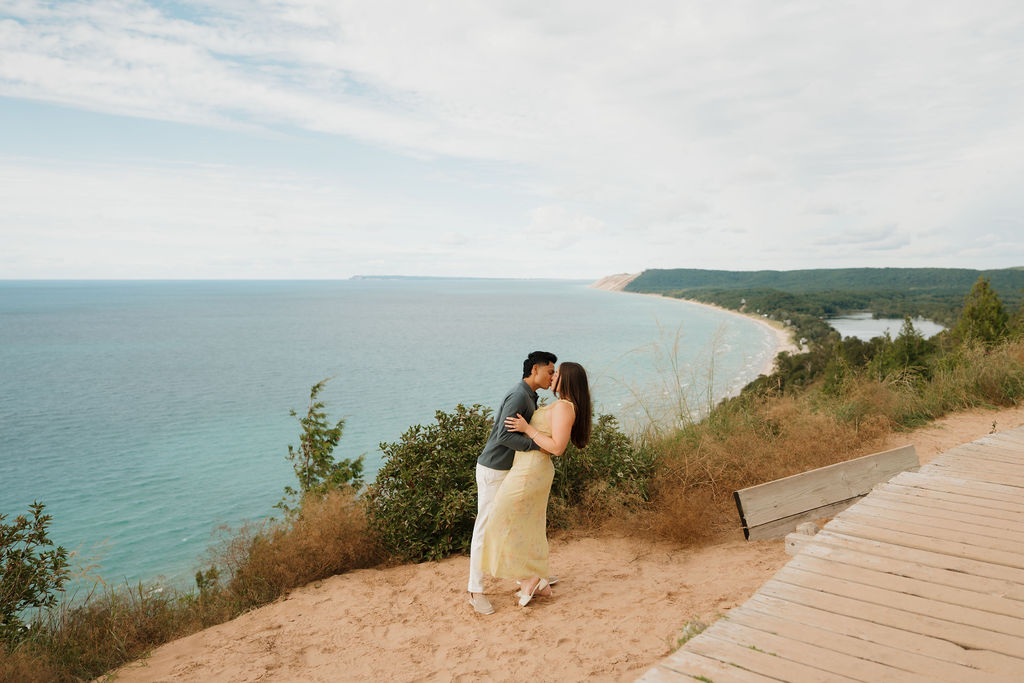 Couple kissing at Empire Bluff Trail after their Sleeping Bear Dunes proposal.