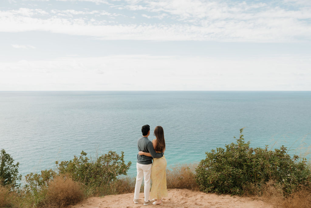 Couple looking over Lake Michigan for photos after their Sleeping Bear Dunes proposal at Empire Bluff Trail.
