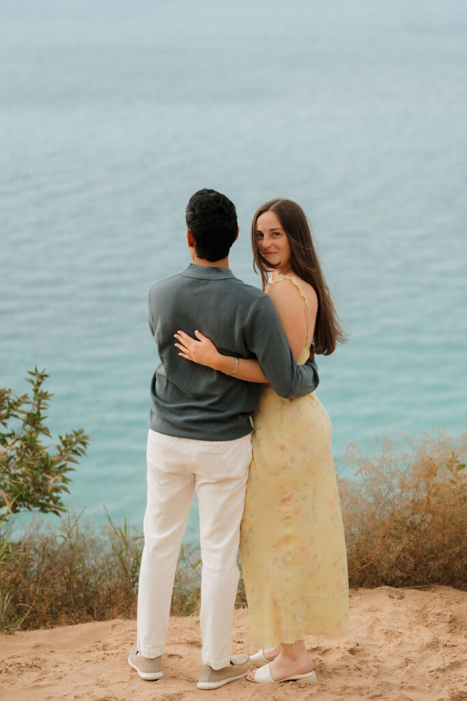 Couple posing together while admiring Lake Michigan.