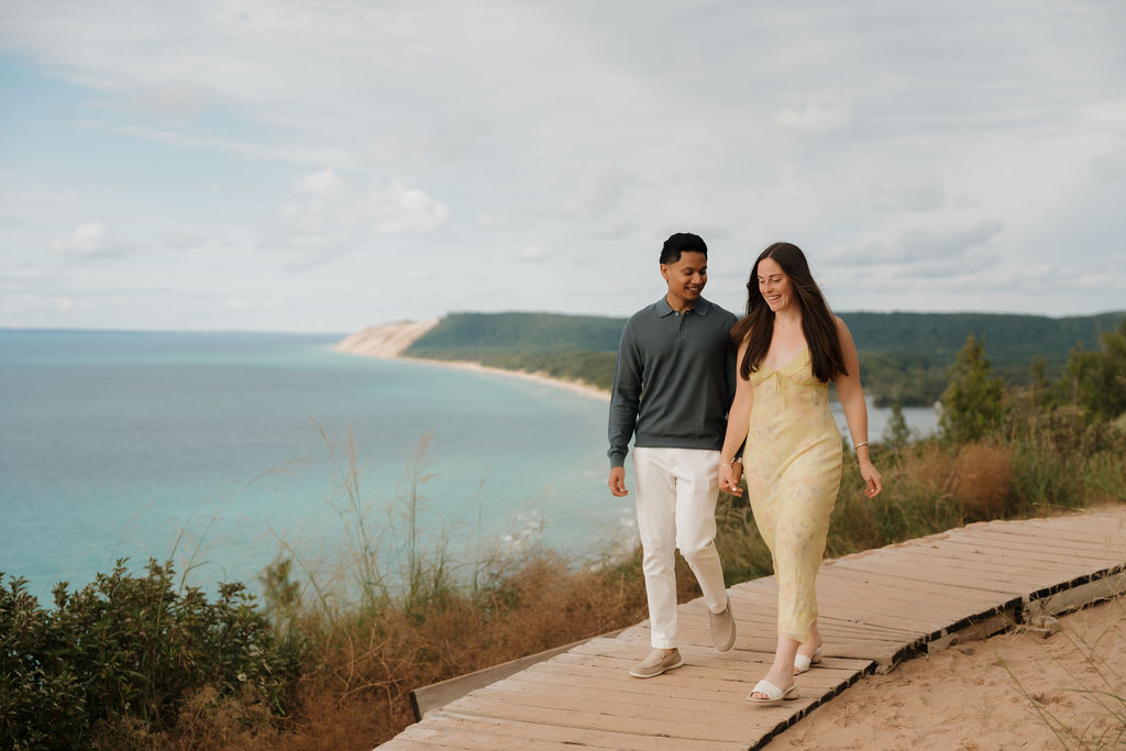 Couple walking the trails at Empire Bluff with Lake Michigan in the background.