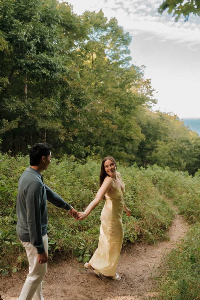 Couple walking along the trails of Empire Bluff for their Sleeping Bear Dunes proposal.