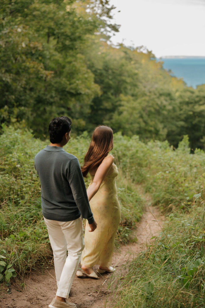 Couple walking along the trails of Empire Bluff for their Sleeping Bear Dunes proposal.