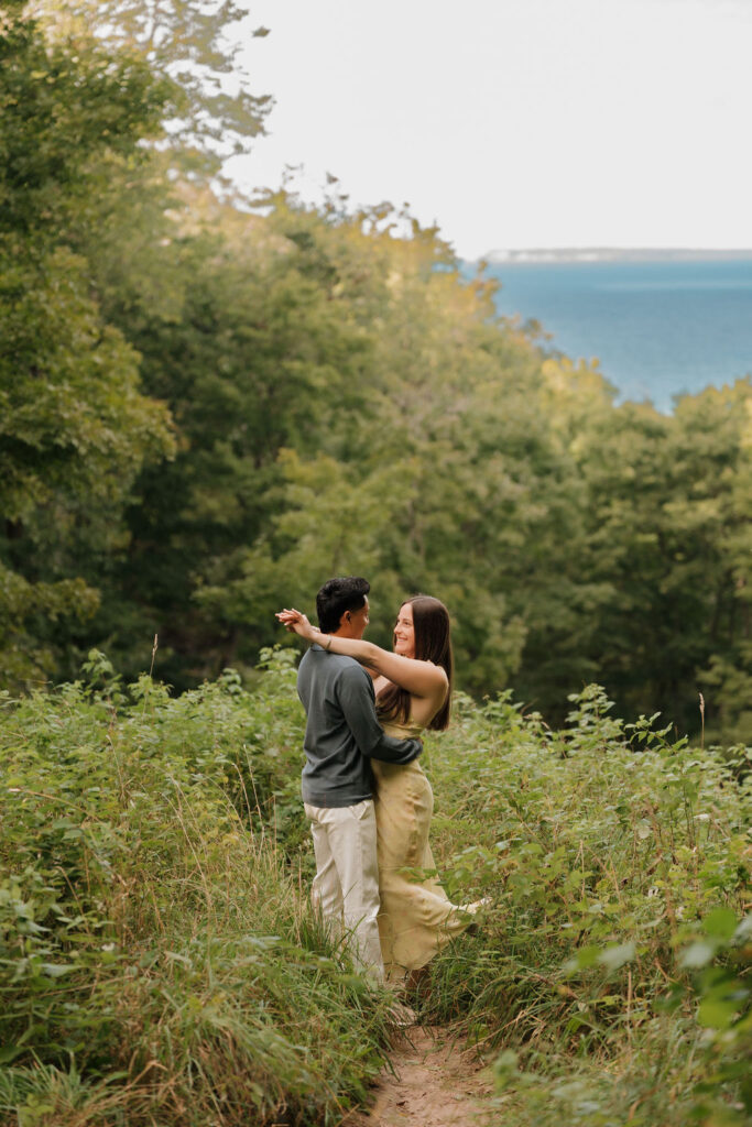 Couple posing along the trails of Empire Bluff for their Sleeping Bear Dunes proposal.