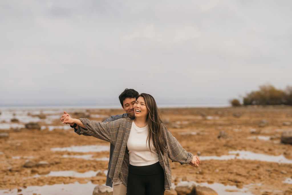Couple posing on the beach for their Traverse City Michigan proposal photos.