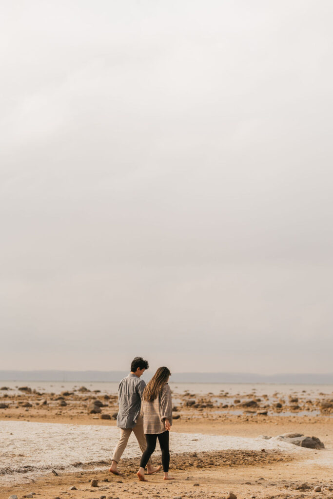Couple walking along the beach in Traverse City Michigan.