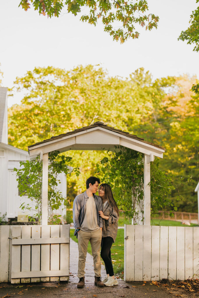 Couple standing underneath an archway at Old Mission Lighthouse in Traverse City Michigan.