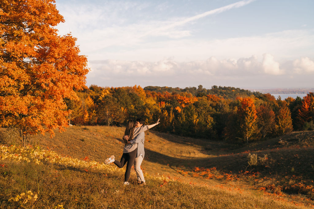 Couple hugging at The Overlook in Traverse City Michigan during the fall.