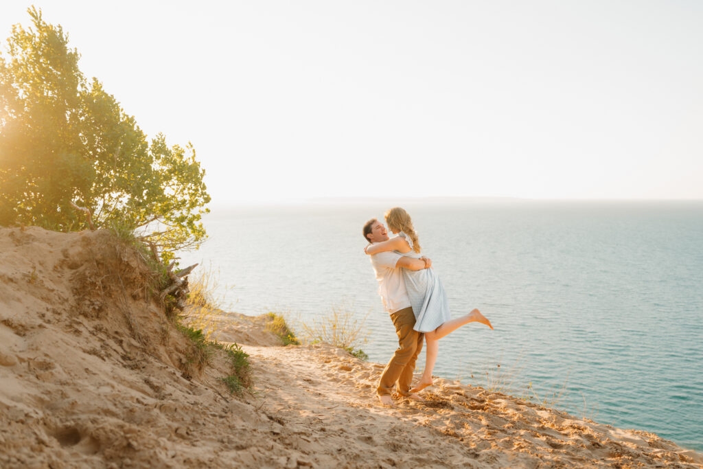 Soon to be husband and wife celebrating their engagement at sleeping bear dunes