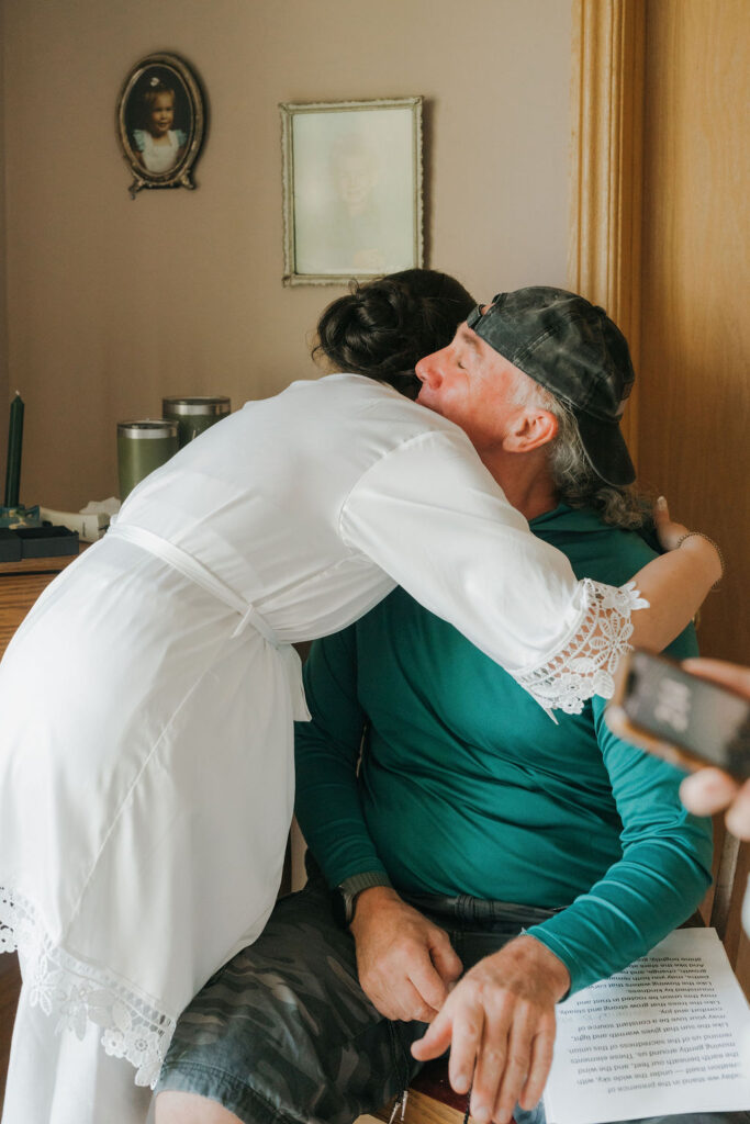 bride hugging family member while getting ready to walk down the aisle at her micro wedding