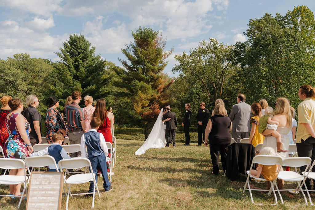 father handing over the bride during the wedding ceremony