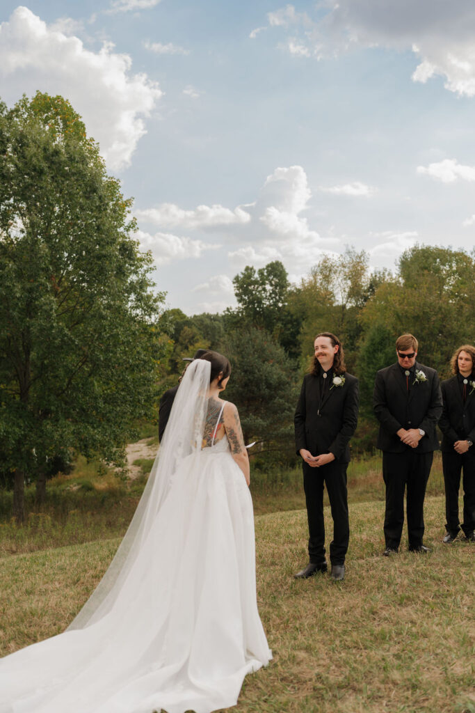 bride and groom having their first look during their wedding ceremony during their micro wedding in brooklyn, MI