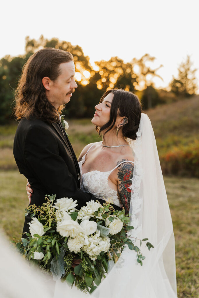 bride looking up at her groom while holding their bouquet