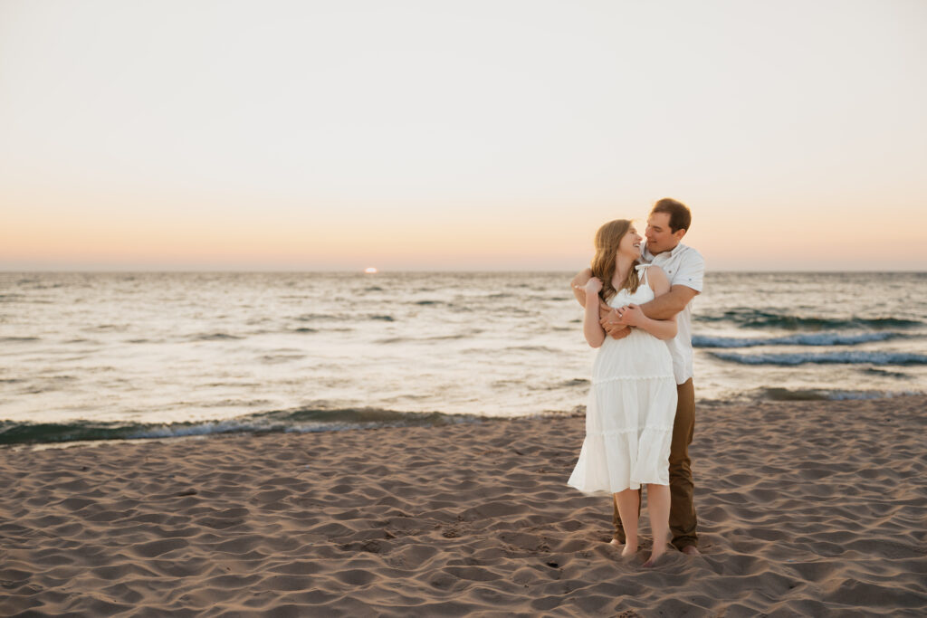 couple laughing and enjoying their time during the sunset at sleeping bear dunes