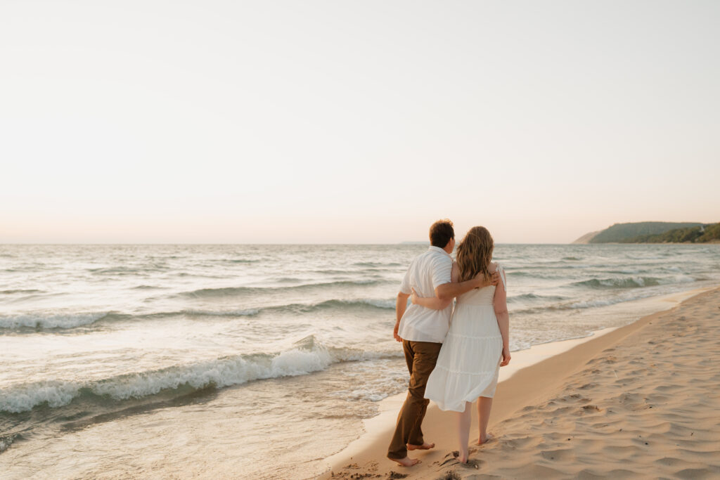 bride and groom walking barefoot across sleeping bear dunes